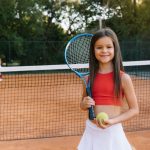 child-playing-tennis-on-outdoor-court-little-girl-2024-01-23-18-54-05-utc-scaled-1